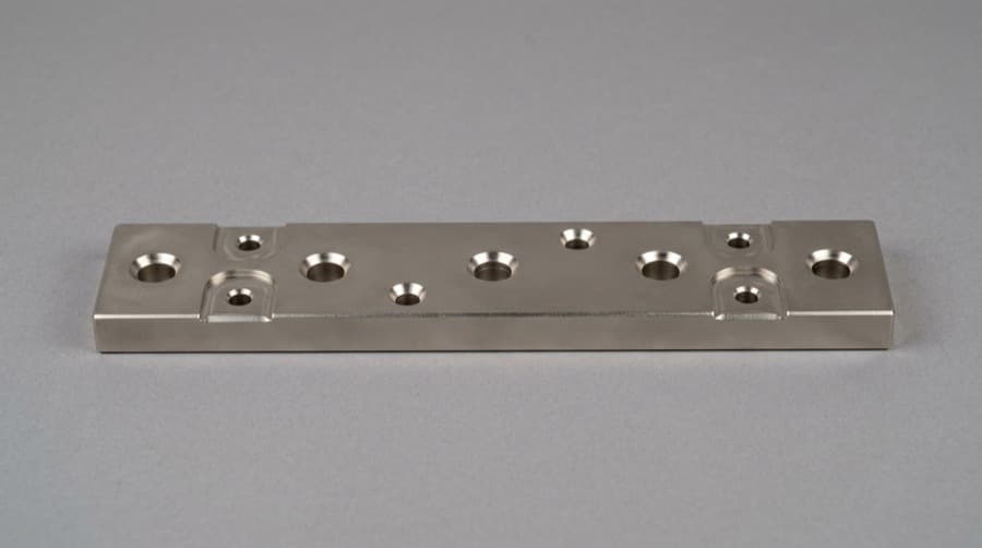 CNC machined copper bus bar with electroless nickel plating — uniform silver-gray finish for corrosion and wear protection